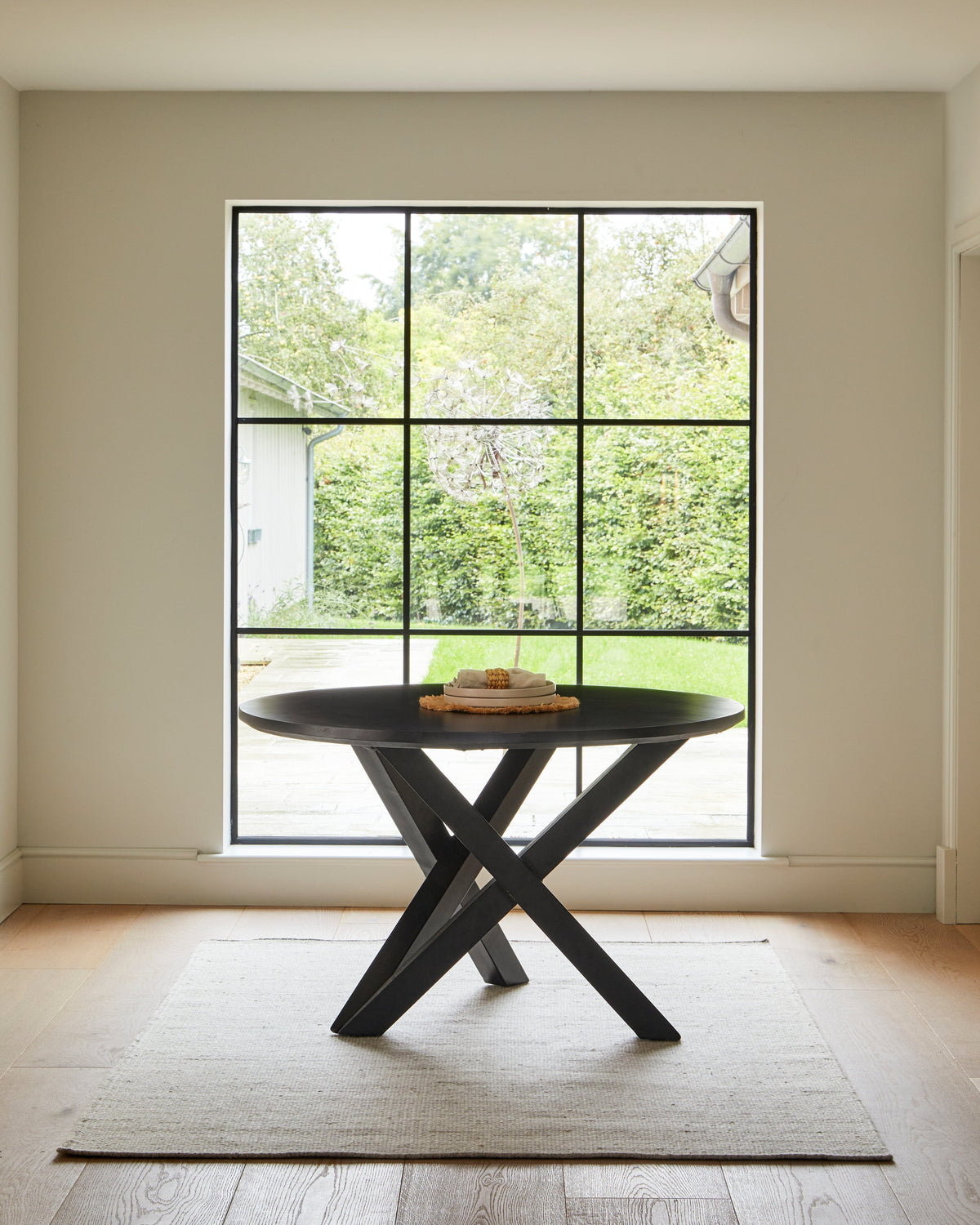 Levi Black Round Dining Table Set - 4 Seater - Freya Boucle Armchairs with Black Legs