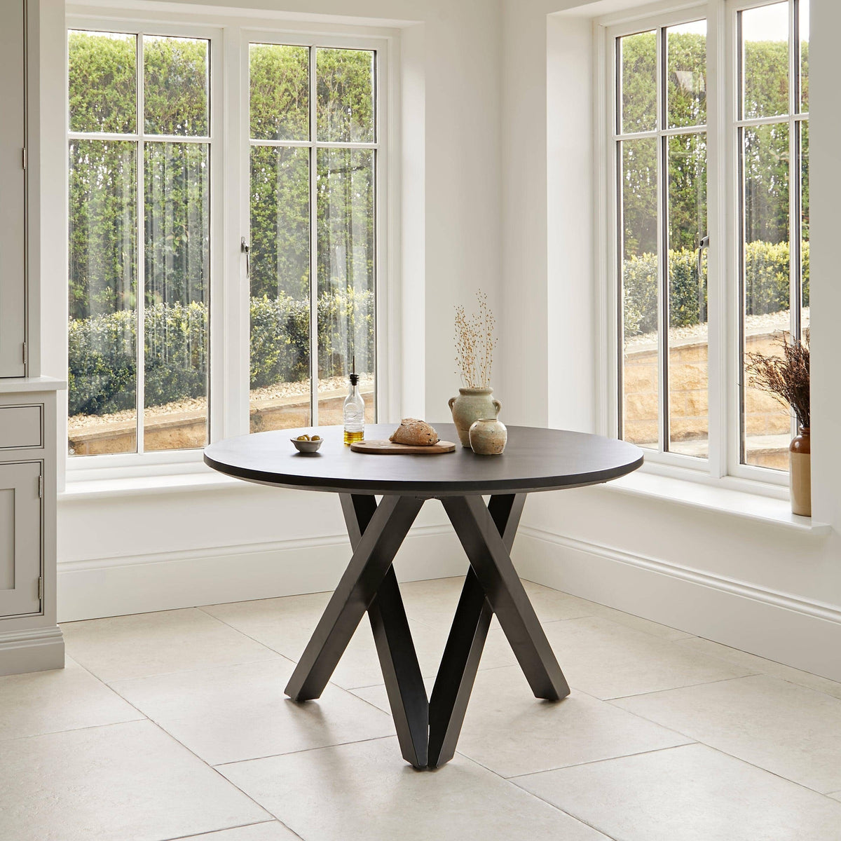 Levi Black Round Dining Table Set - 4 Seater - Freya Sand Dining Chairs - Black Oak legs
